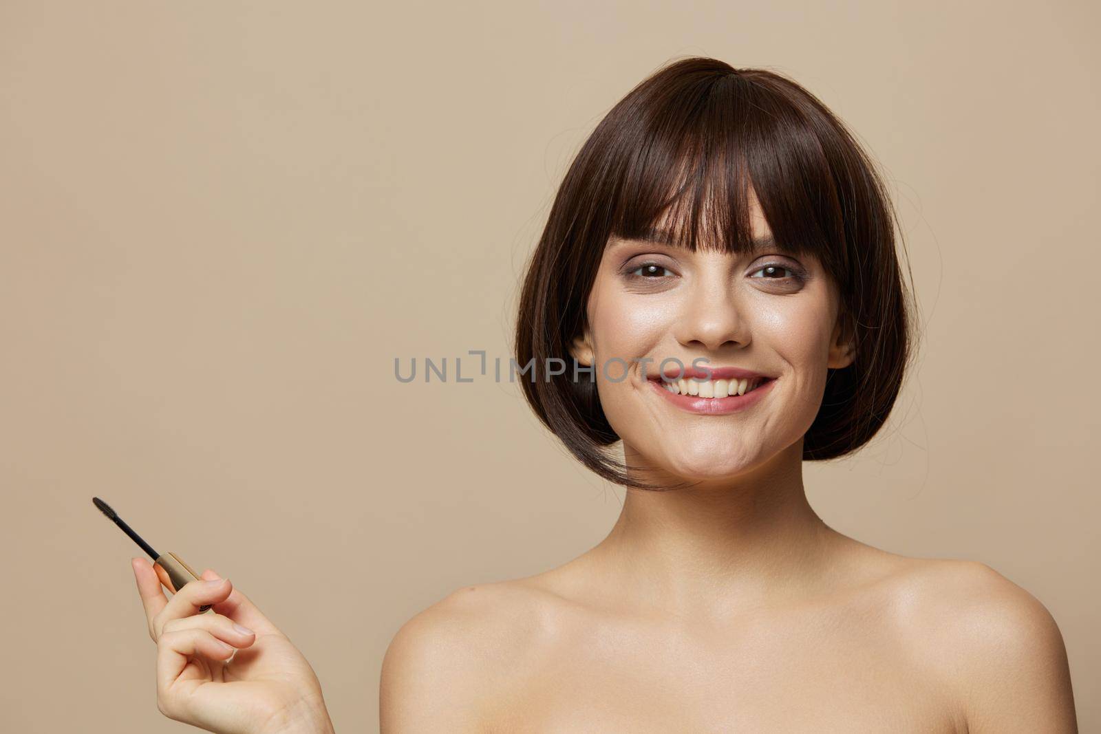 beautiful woman eyelash brush model makeup posing isolated background. High quality photo