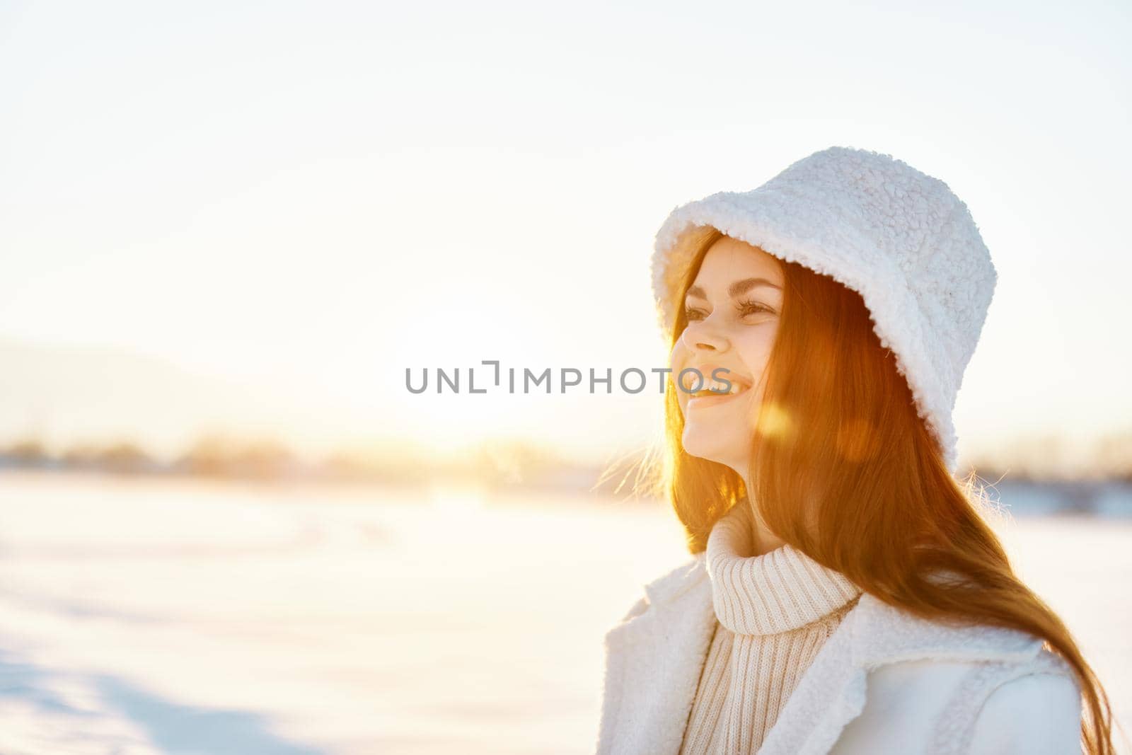 young woman red hair snow field winter clothes Sunny winter day Fresh air. High quality photo