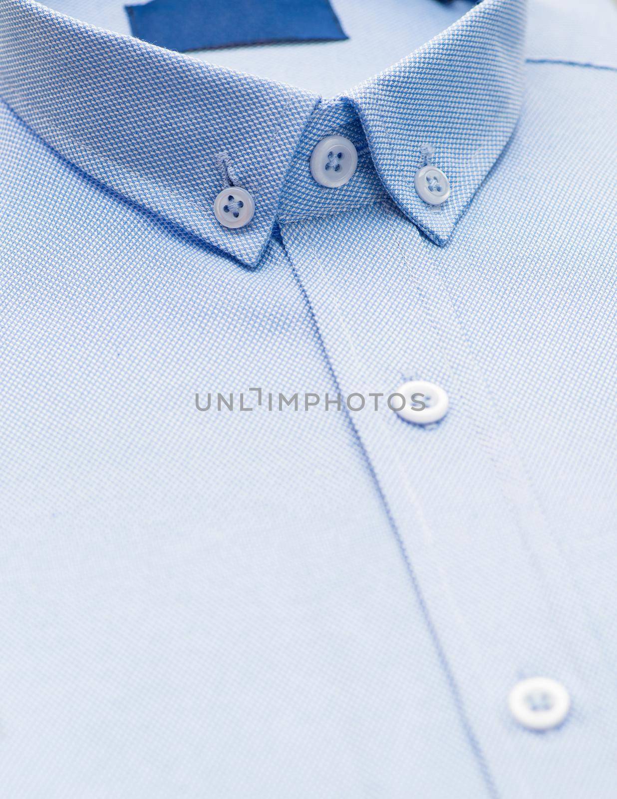 blue shirt with a focus on the collar and button, close-up