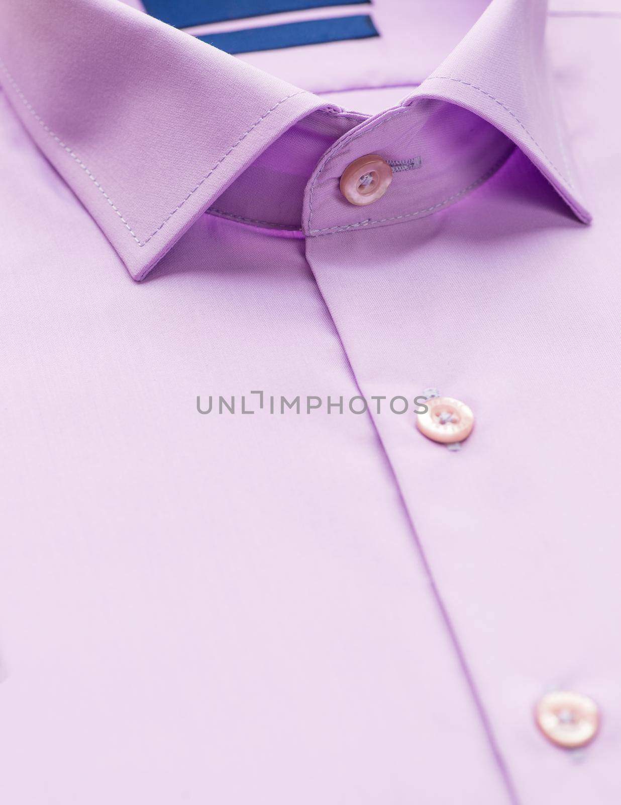 pink shirt with a focus on the collar and button, close-up