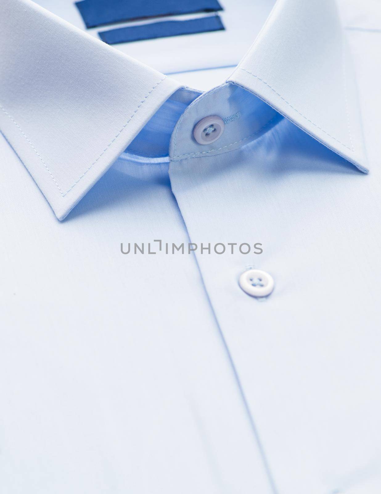 blue shirt with a focus on the collar and button, close-up