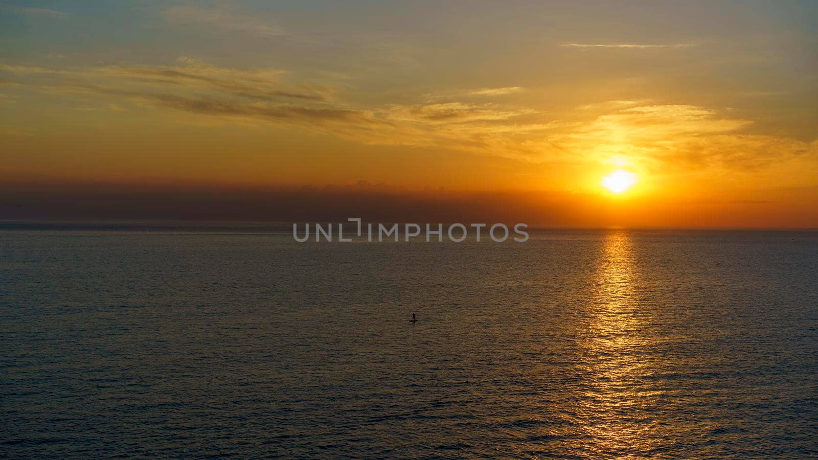Seascape with a beautiful sunset over the water surface. by Vvicca