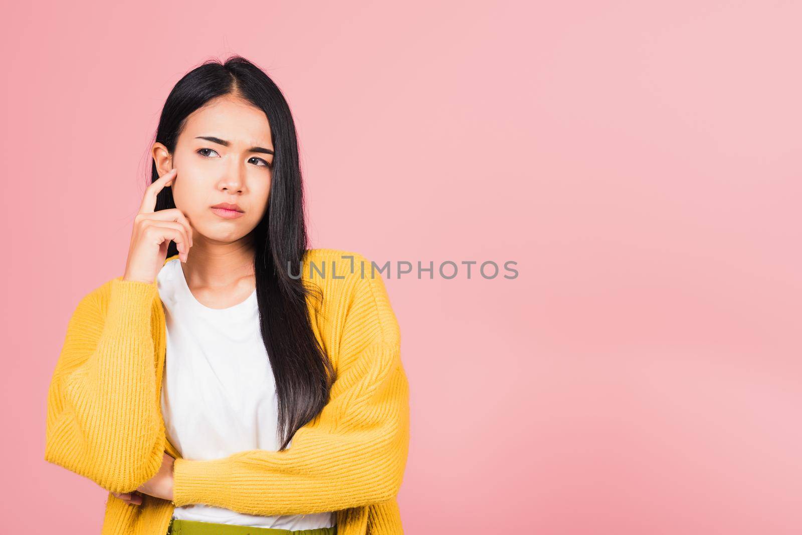 Portrait Asian beautiful young woman standing chin handle relaxed thinking about something about the question studio shot isolated on pink background, Thai female idea think with copy space