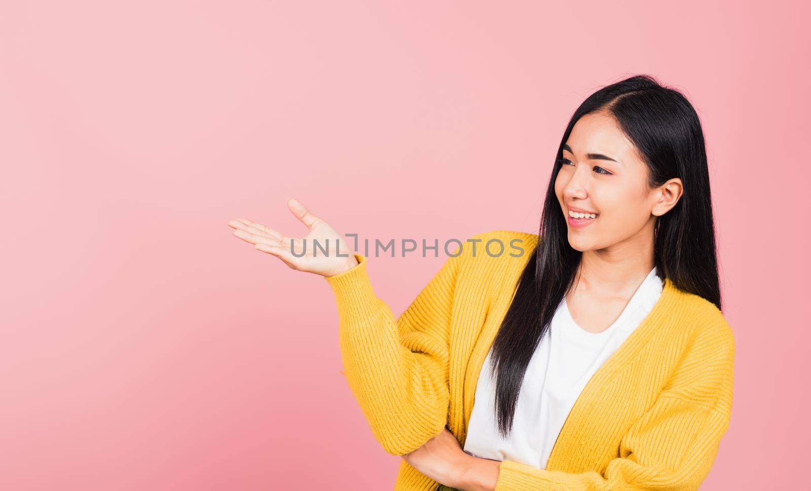 woman smile standing presenting product holding something on palm away side by Sorapop