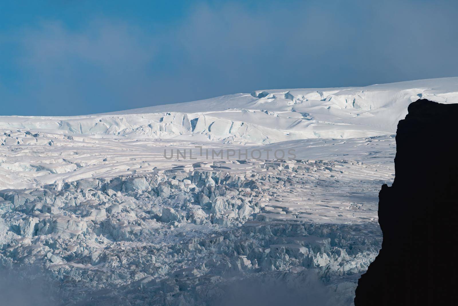 Glaciar, blue sky and dark mountain profile by FerradalFCG