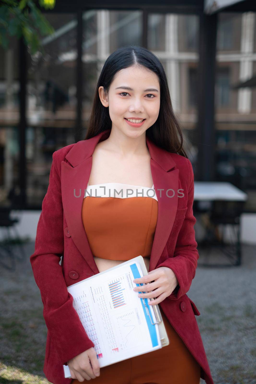 Smiling and happy asian businesswoman looking at camera. Finance and Accounting concept. by itchaznong