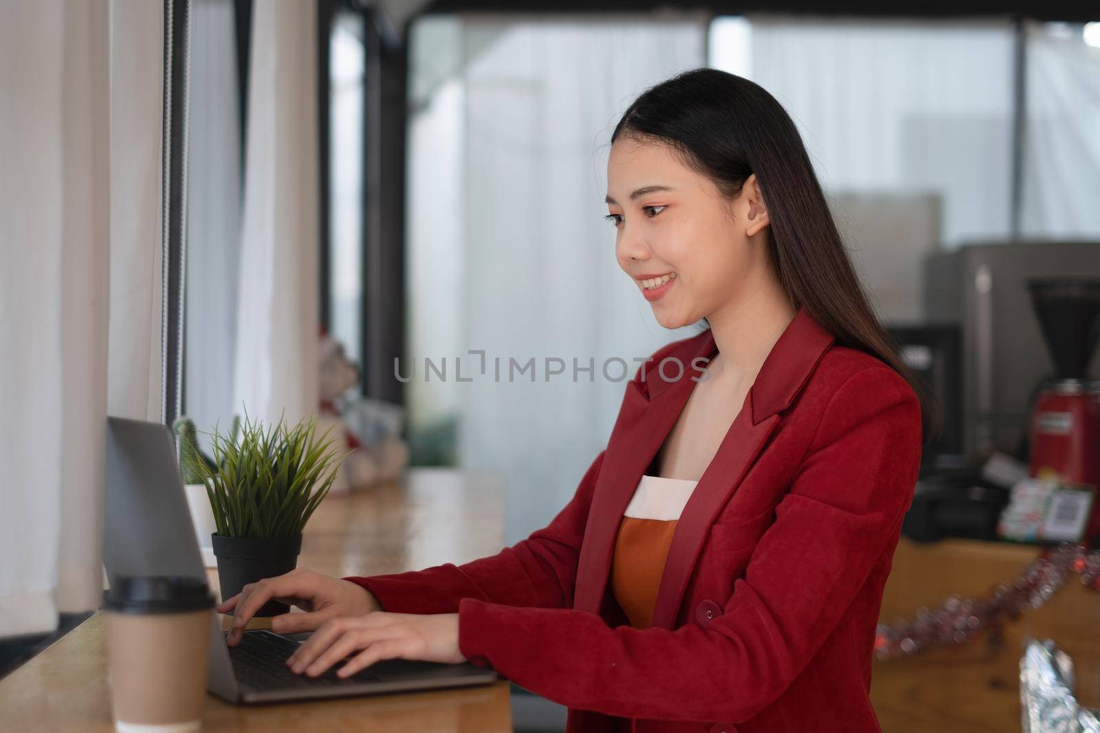 A business woman using laptop computer to cyber security for her saving account, business, technology, future, digital asset Concept