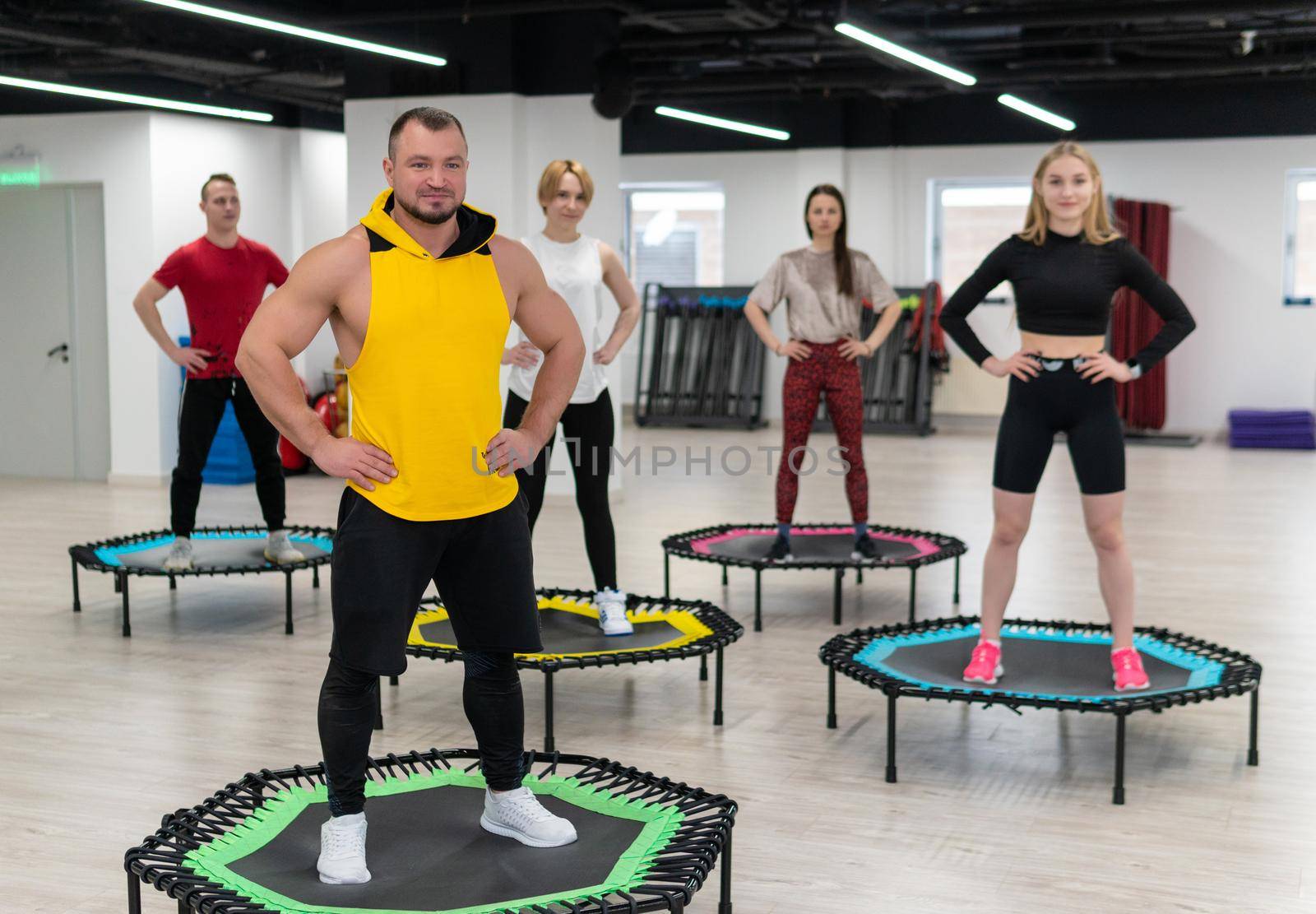 Women's and men's group on a sports trampoline, fitness training, healthy life - a concept trampoline group batut instructor healthy, from female team for sporty and exercise motion, smiling beautiful. Legs beauty athlete, coach by 89167702191