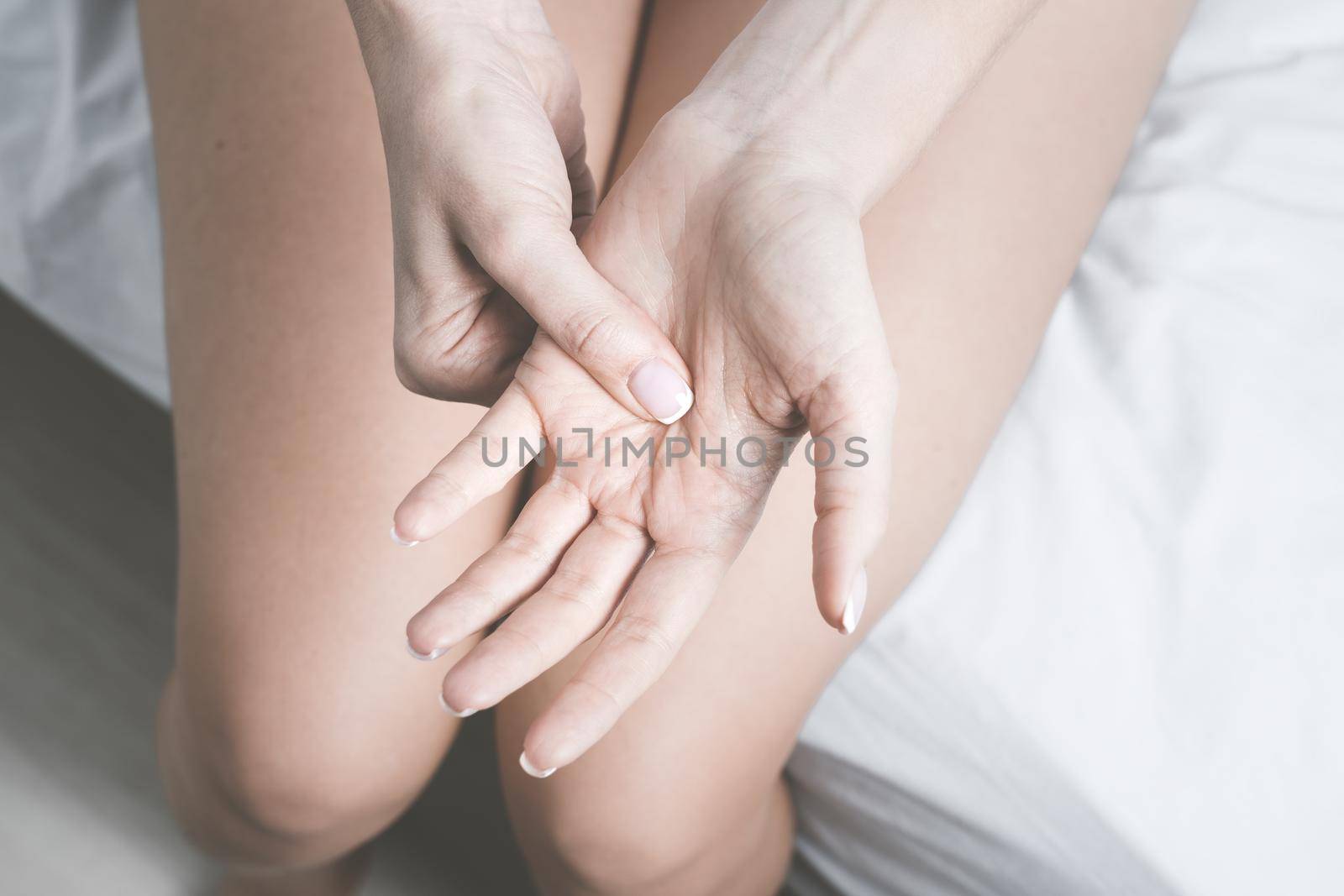 Woman with hand pain in palm. Hand numbness or limb numbness. Massaging painful hand. High quality photo