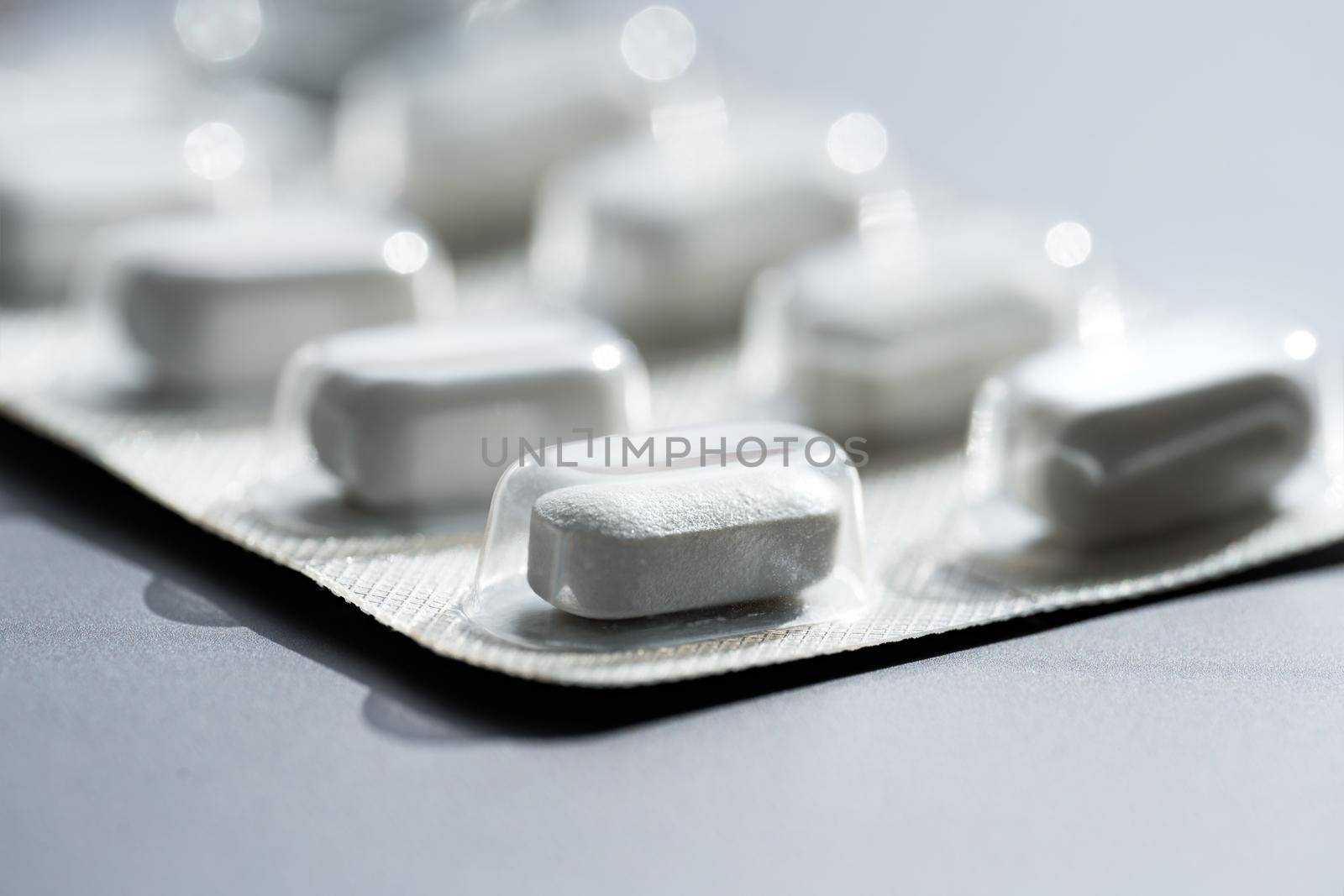 Closeup of pills or tablets in blister pack. Headache pills, painkillers, antibiotics or antidepressants. High quality photo