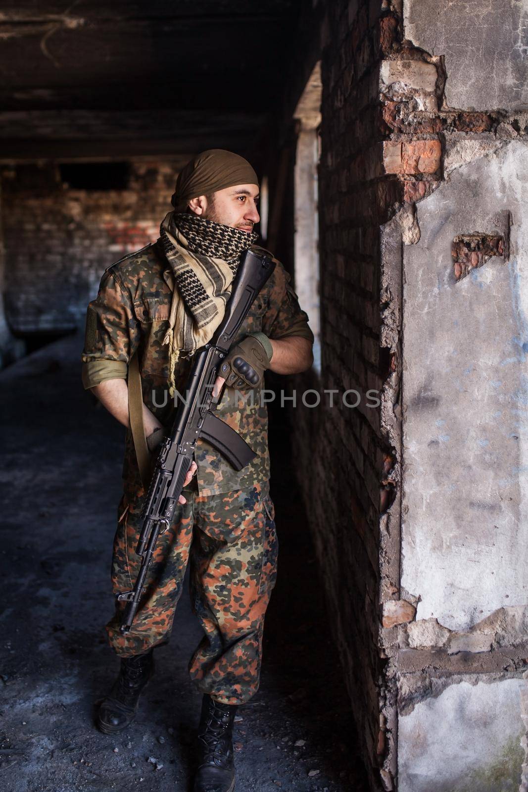 Portrait of serious middle eastern man with AK-47