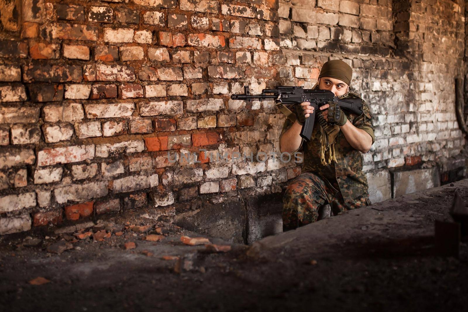 Arab soldier aiming with Kalashnikov AK-47 assault rifle.