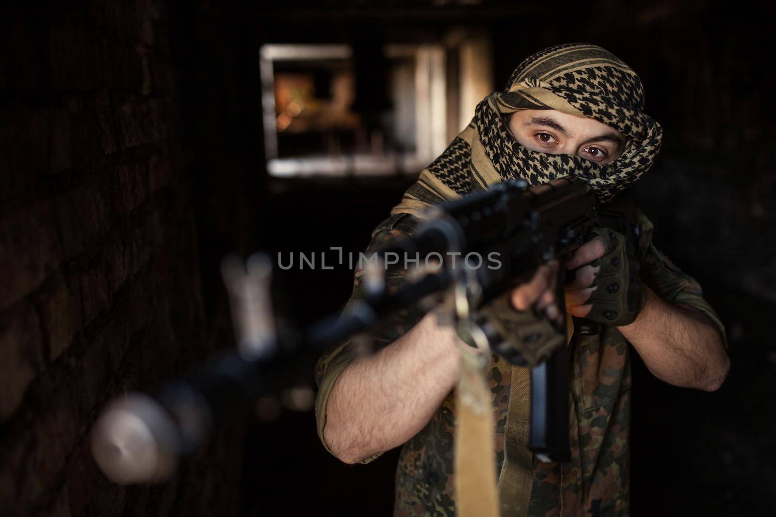 Arab soldier aiming with Kalashnikov AK-47 assault rifle.