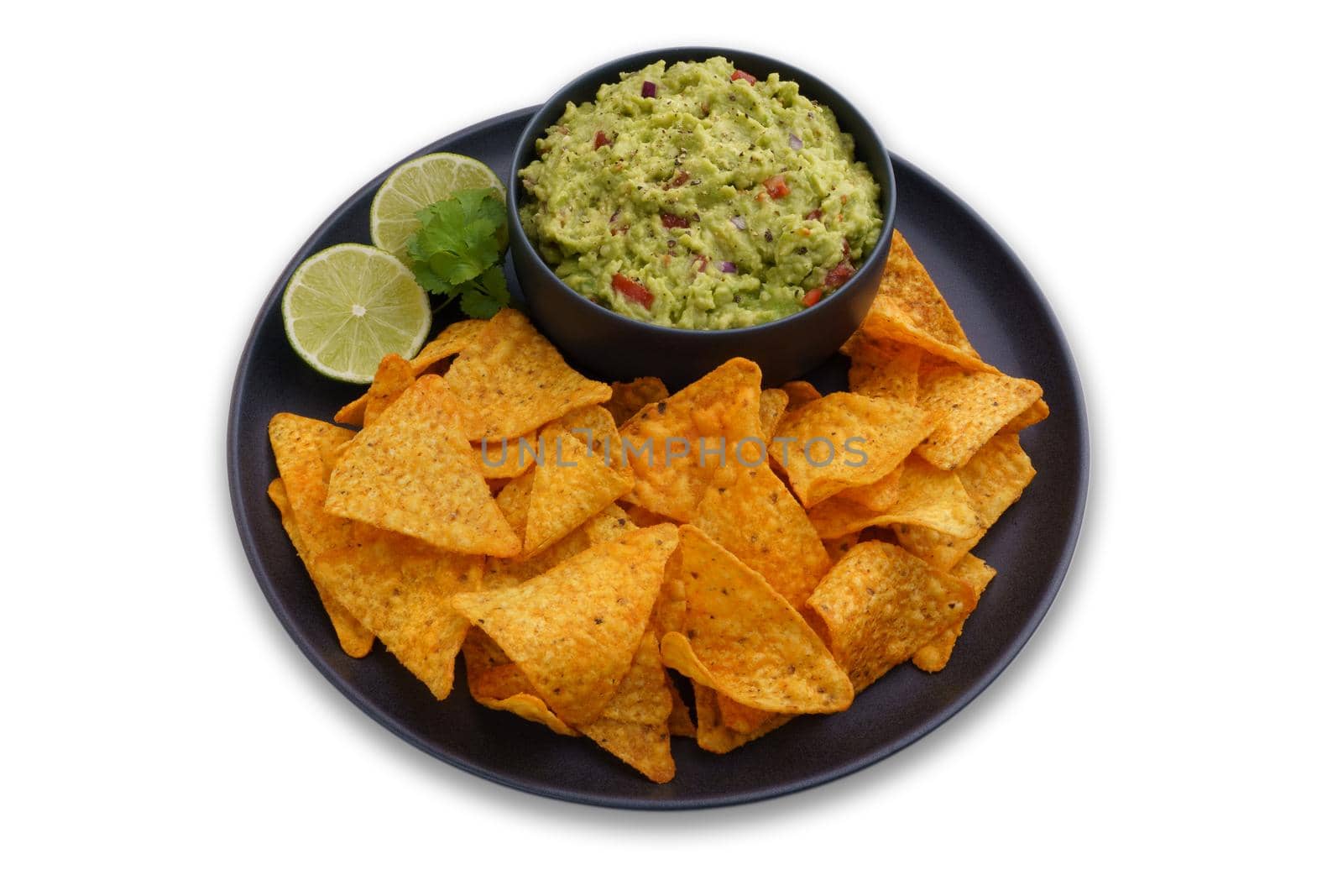 Black plate of guacamole dip and tortilla chips or nachos isolated on a white background. High quality photo