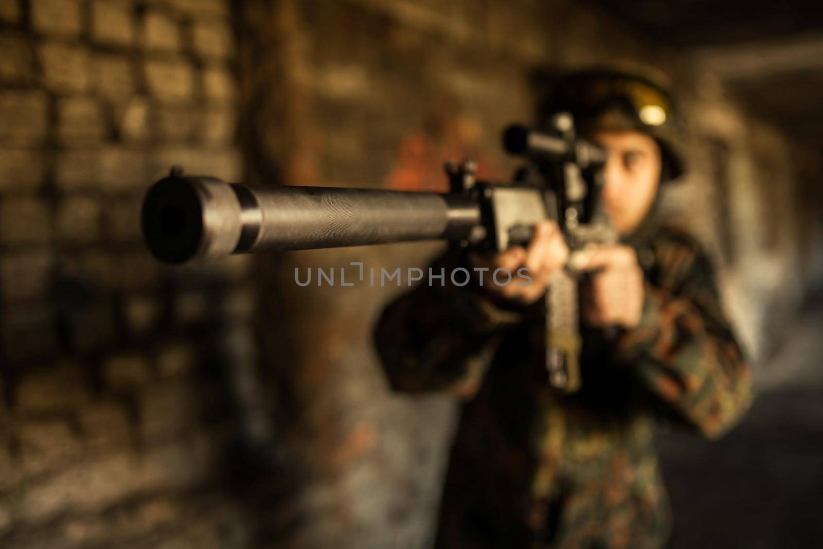 Soldier in war, with weapons in his hands, aim at the enemy