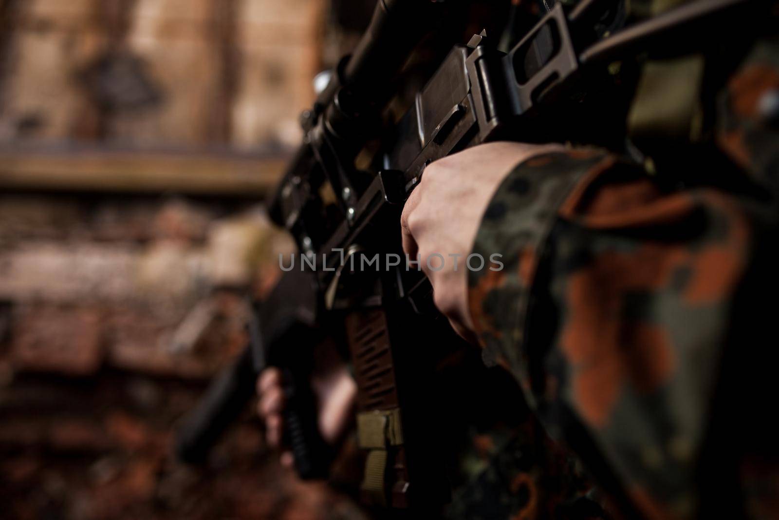 Soldier in war, with weapons in his hands, aim at the enemy