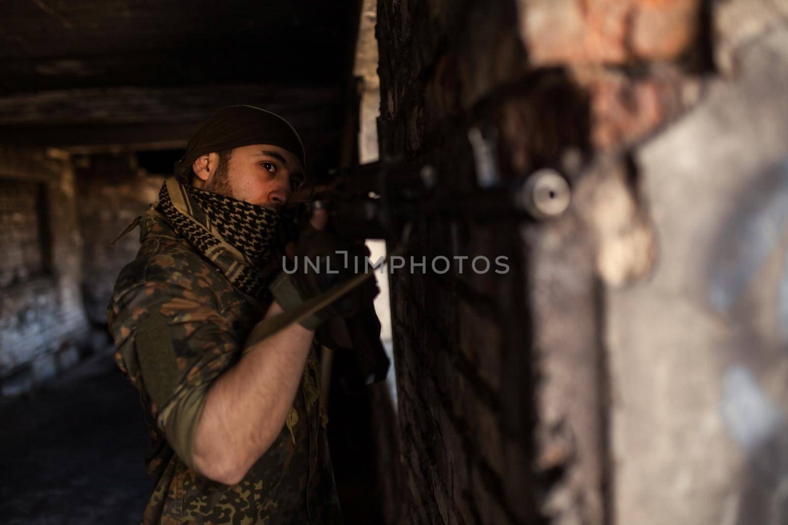 Arab soldier aiming with Kalashnikov AK-47 assault rifle.