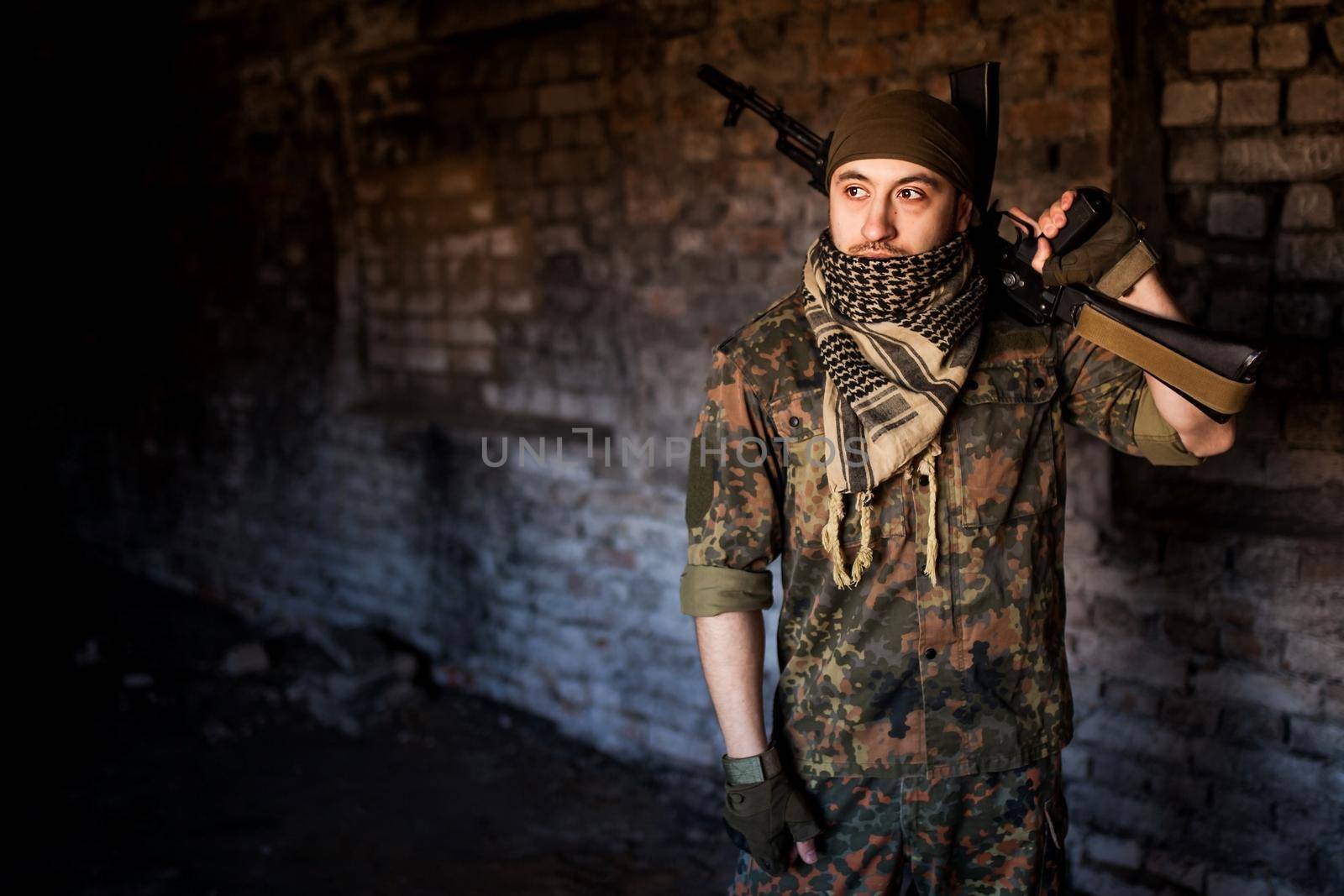 Portrait of serious middle eastern man with AK-47