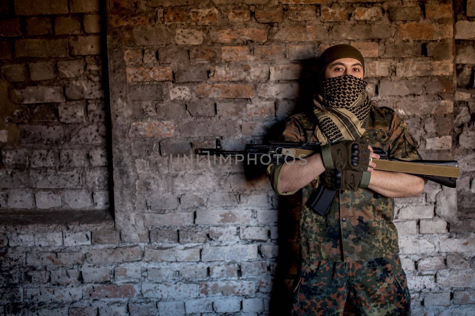 Portrait of serious middle eastern man with AK-47