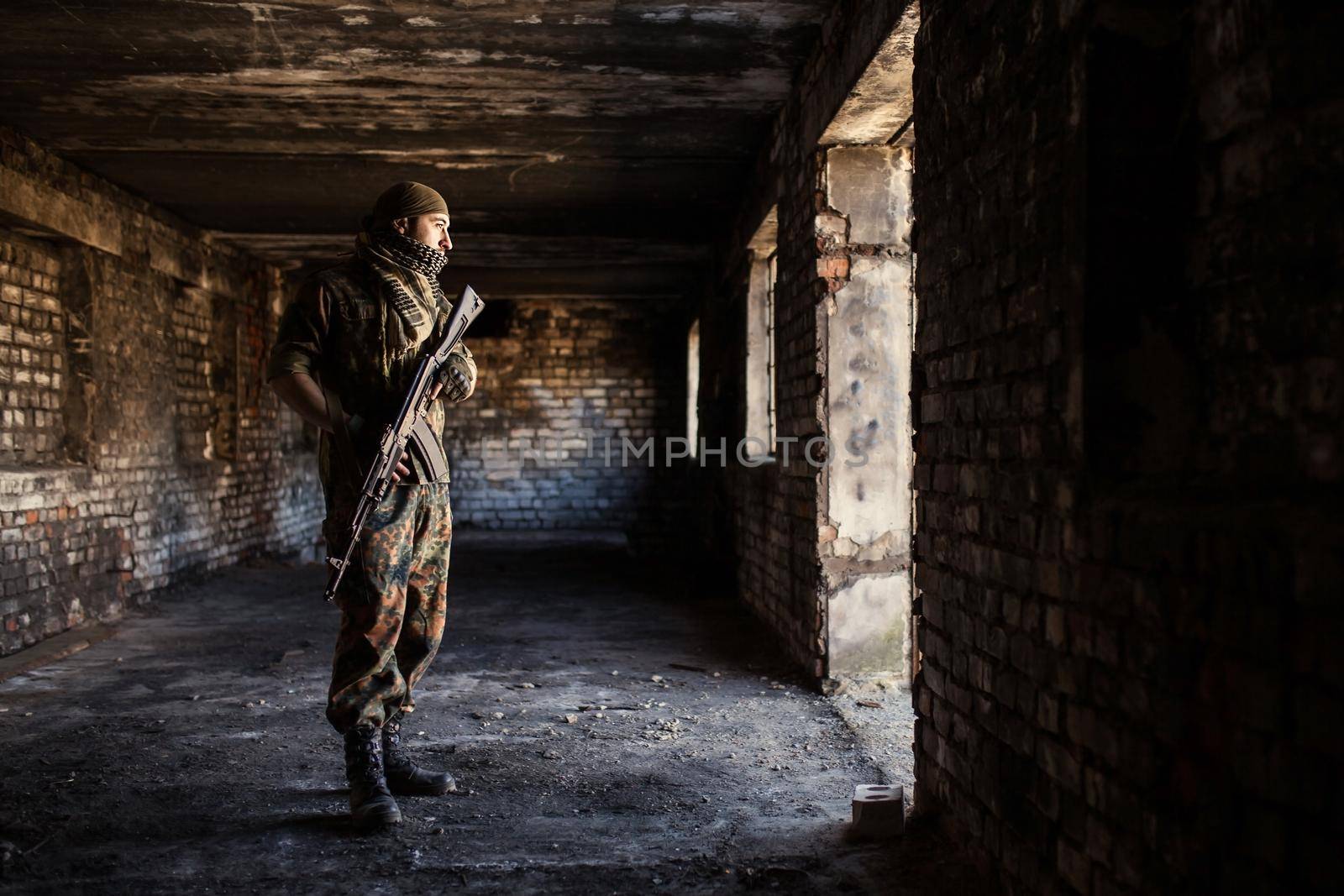Portrait of serious middle eastern man with AK-47