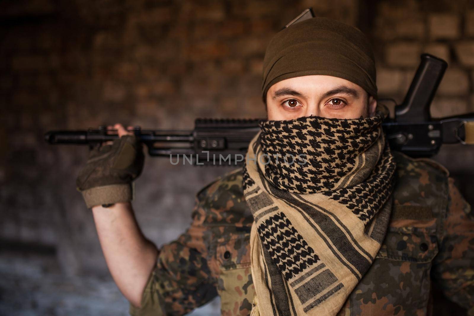 Portrait of serious middle eastern man with AK-47