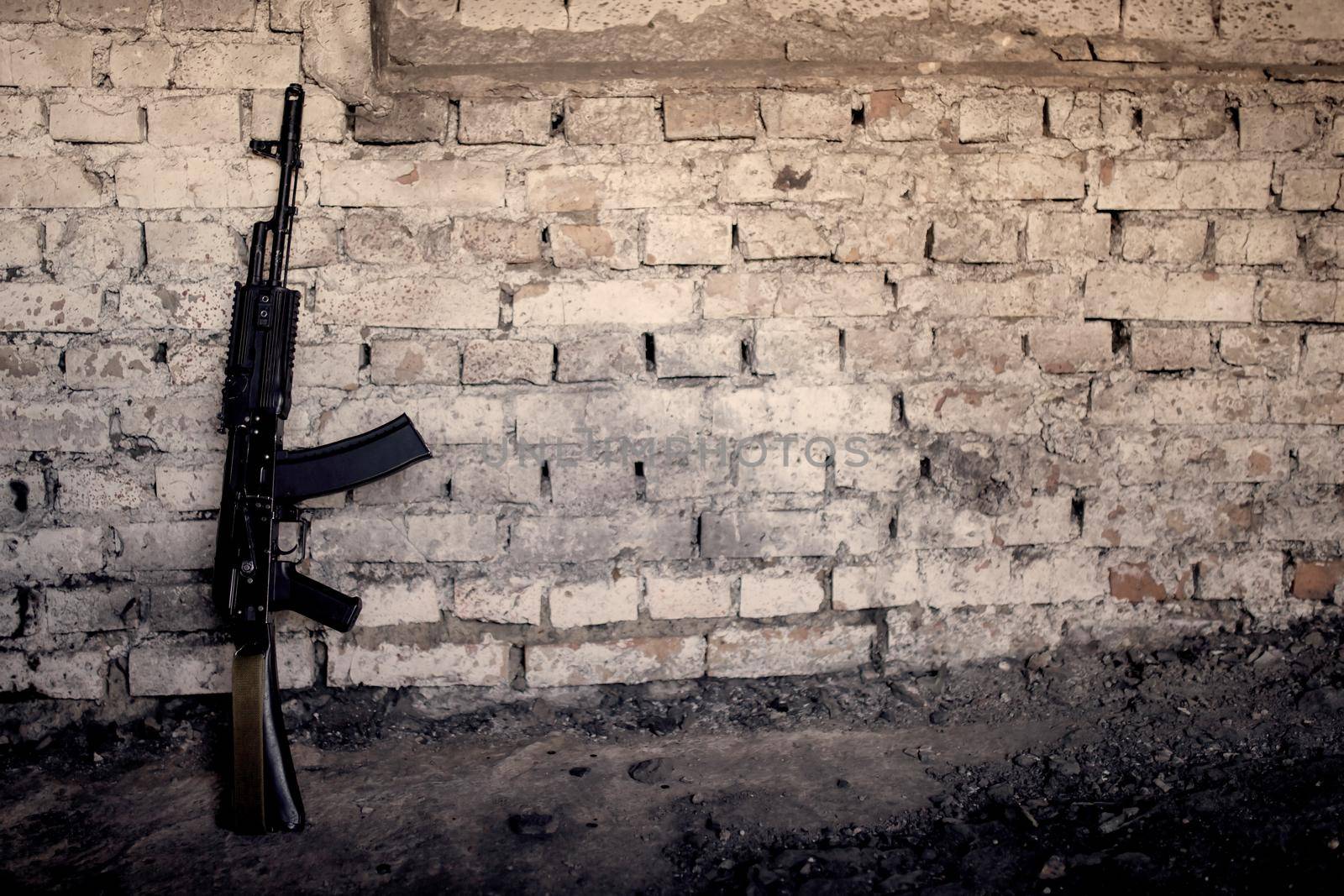 old submachine gun kalashnikov AK-47 against the wall