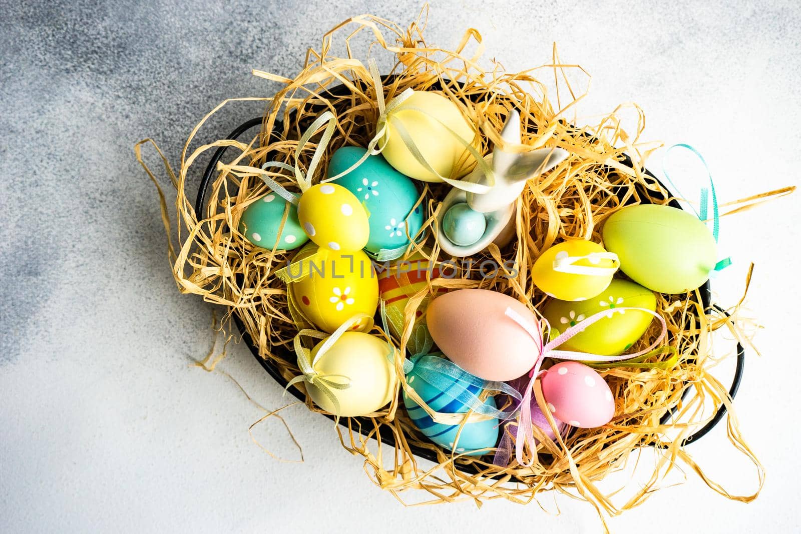 Box full of colorful eggs on rustic background