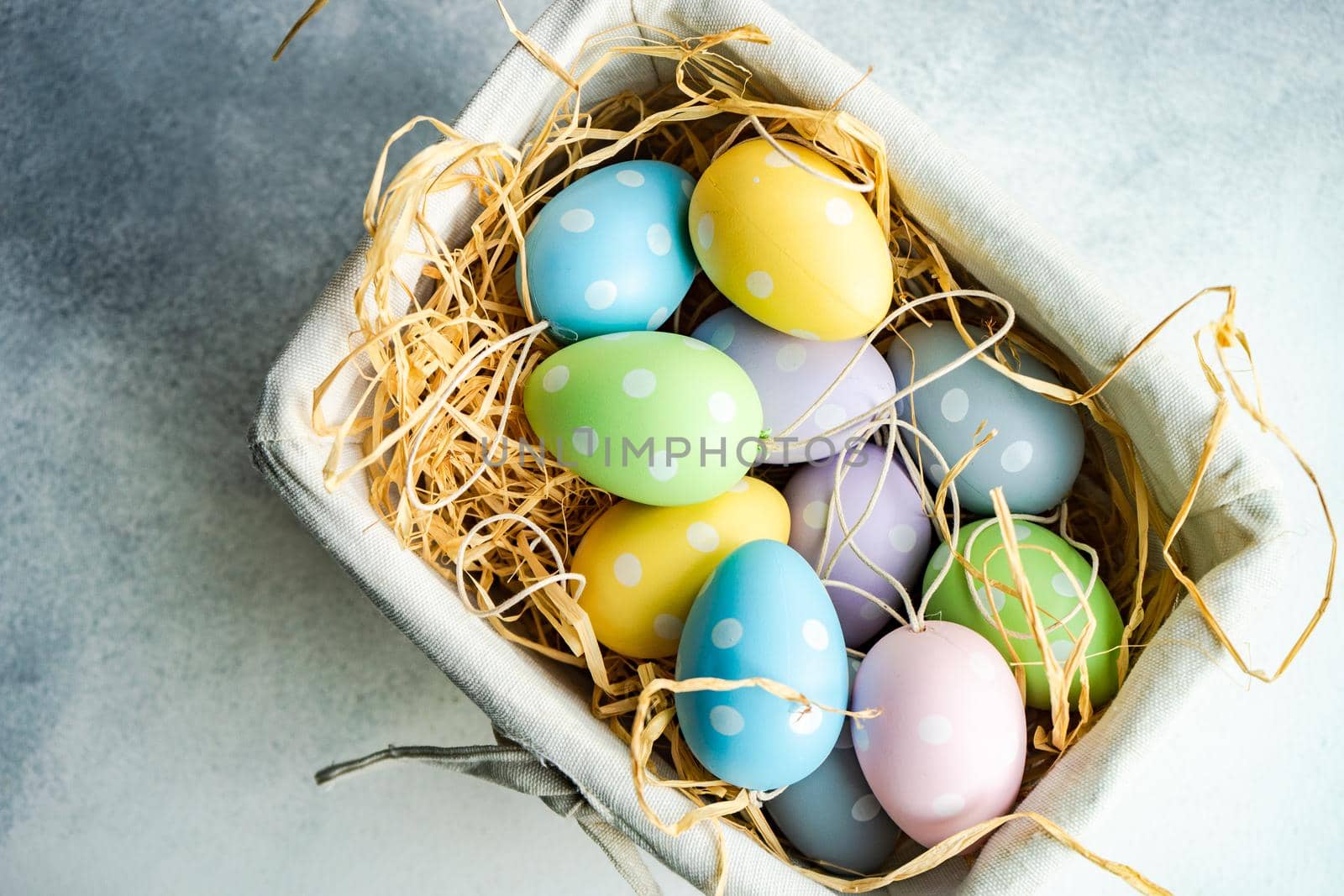 Box full of colorful eggs on rustic background