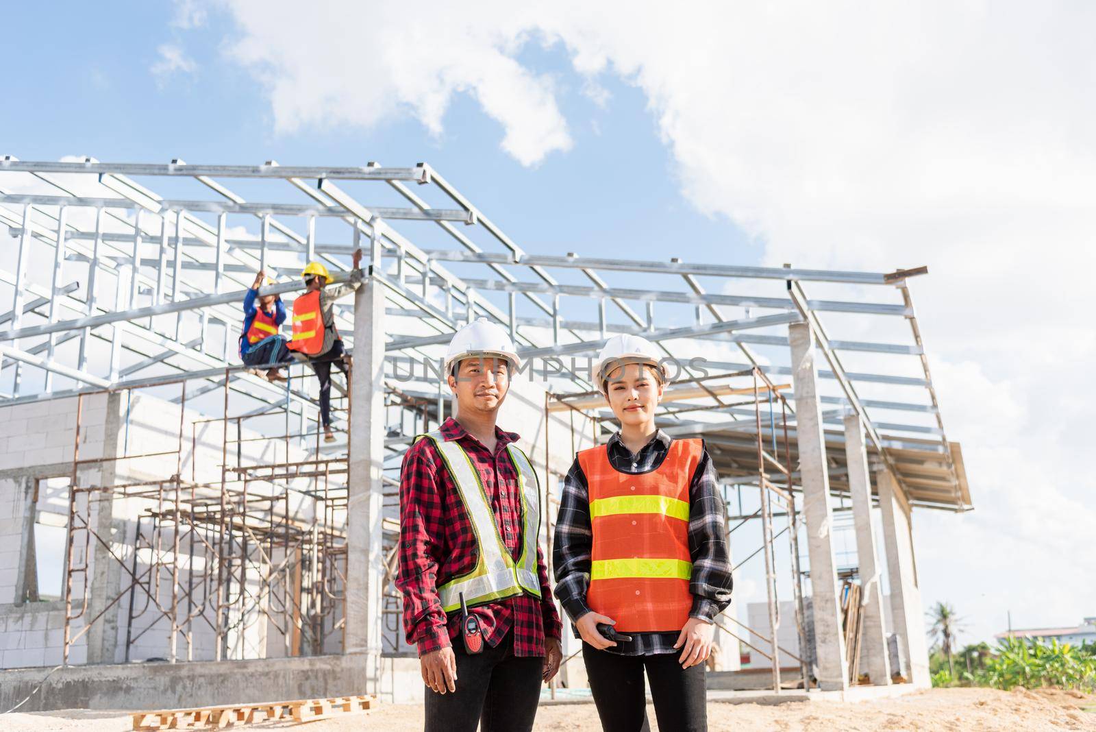 Architect and client standing at home building construction site. Portrait Asian engineer foreman worker man and woman in hardhat posing on building, Concept for team work