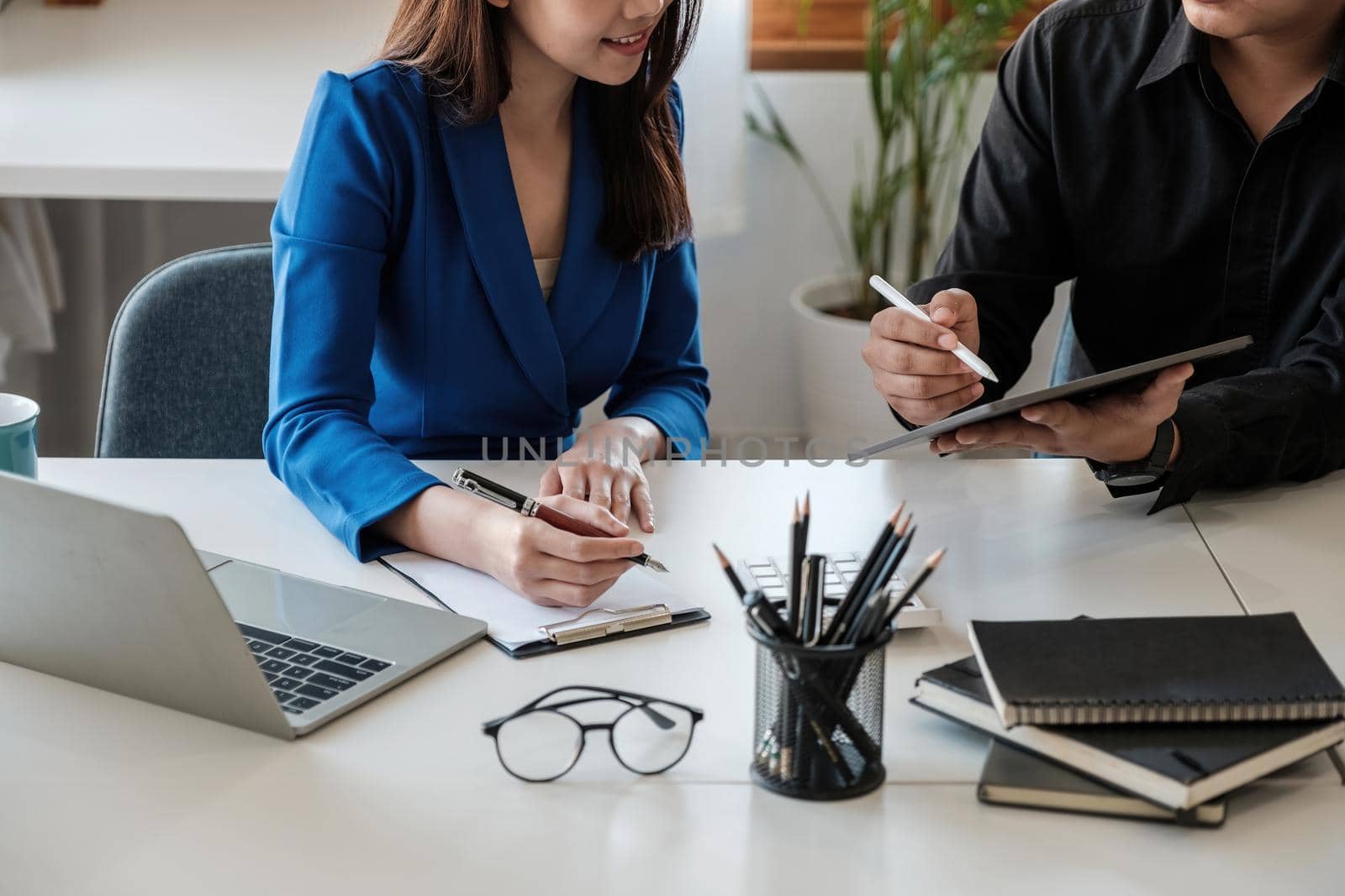 Asian business adviser meeting to analyze and discuss the situation on the financial report in the meeting room.Investment Consultant,Financial Consultant,Financial advisor and accounting concept.