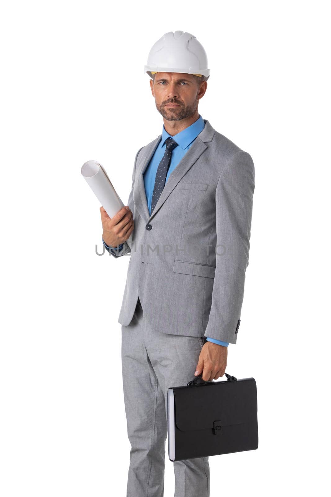 Male construction architect in formal suit and hardhat with rolled blueprints looking at camera isolated on white background