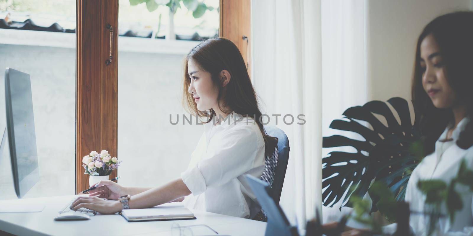 Asian business woman or accountant using computer desktop talk to colleagues for briefing business plan in video call. finance fund investment concept