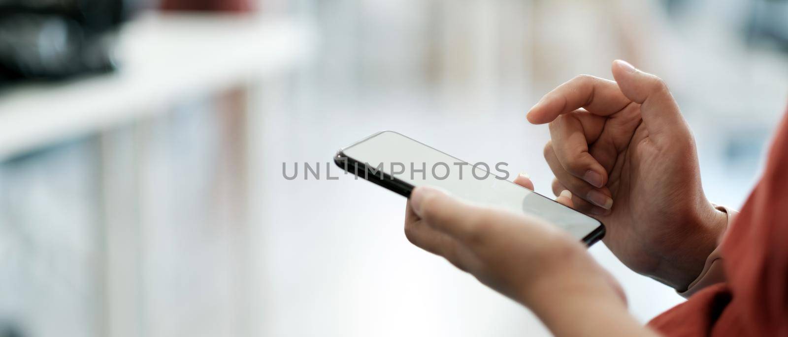 Close up woman using smart phone with hand finger touch screen, texting, chatting or social media.