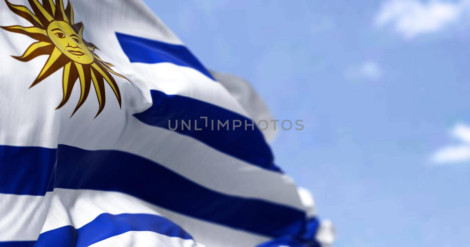 Detail of the national flag of Uruguay waving in the wind on a clear day. Democracy and politics. Patriotism.South american country. Selective focus.