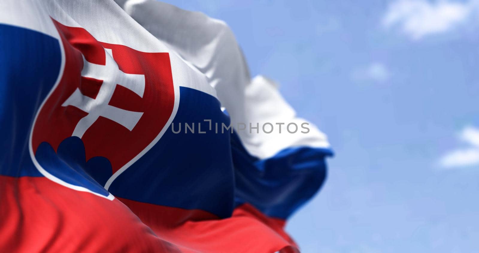 Detail of the national flag of Slovakia waving in the wind on a clear day by rarrarorro