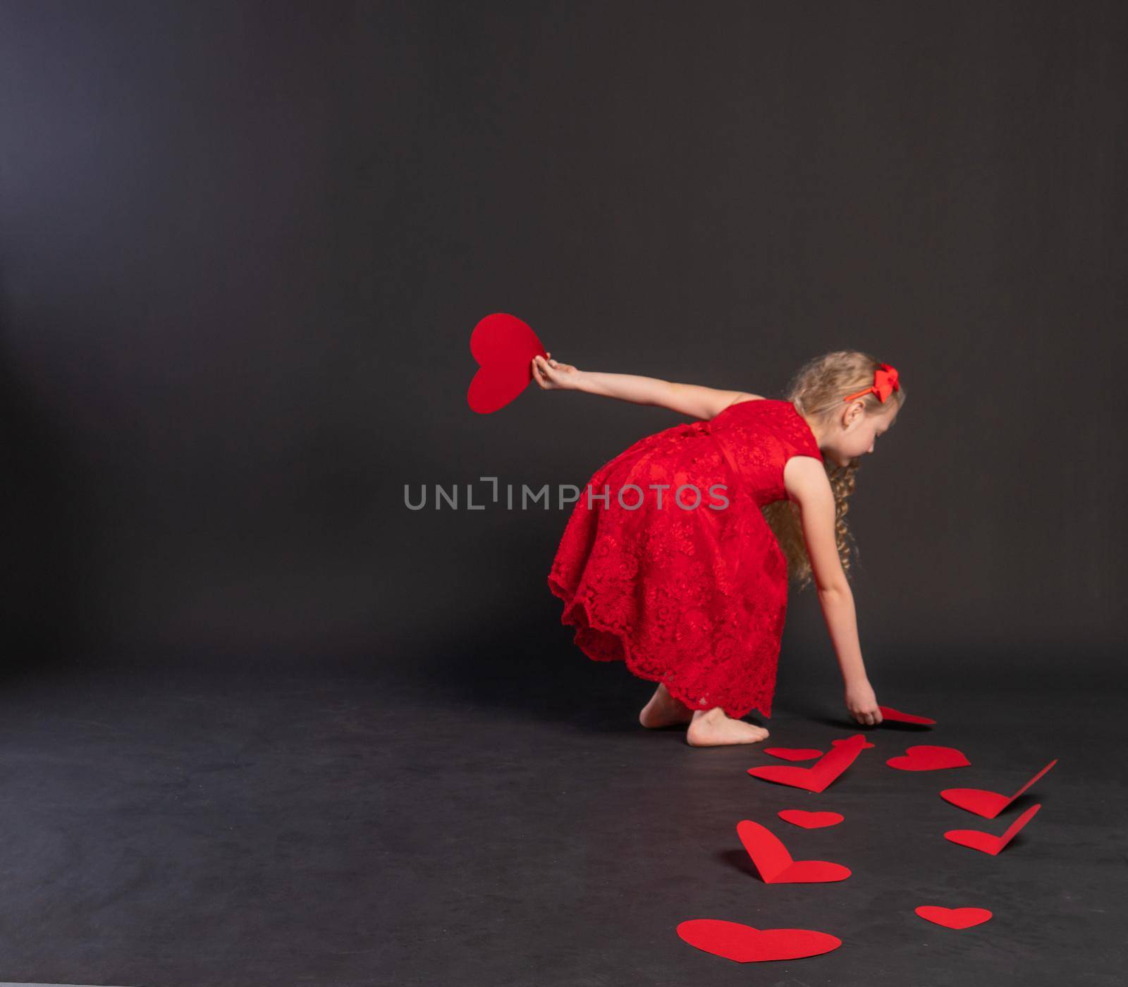 paper hearts love symbol, valentine's board, on the floor hearts married space. February 14, the honeymoon. a gift in a red dress girl, barefoot by 89167702191