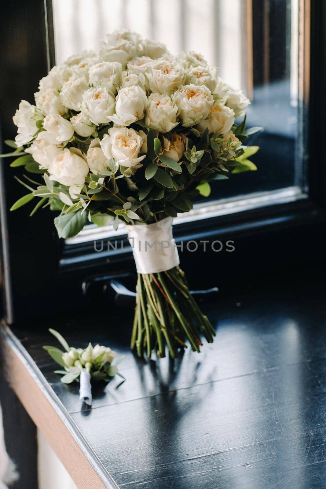 Wedding bouquet of roses lying on the surface. Wedding floristry by Lobachad