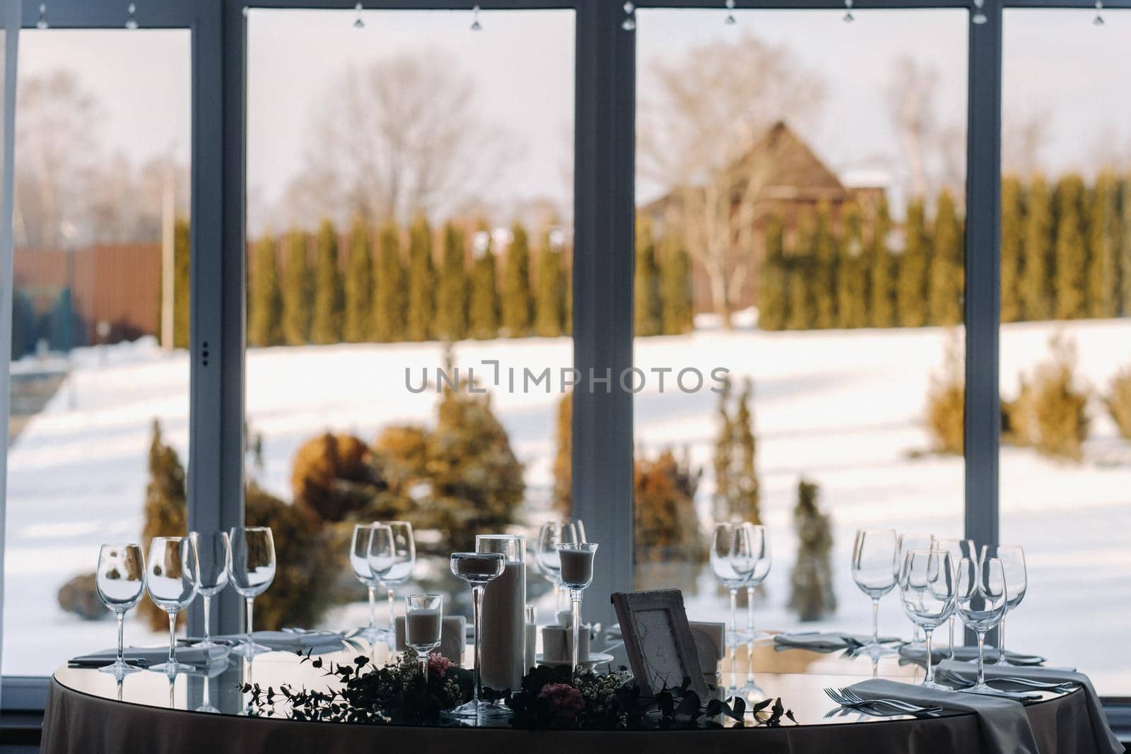 Decorated Table for a wedding reception in a restaurant .Wedding decor by Lobachad