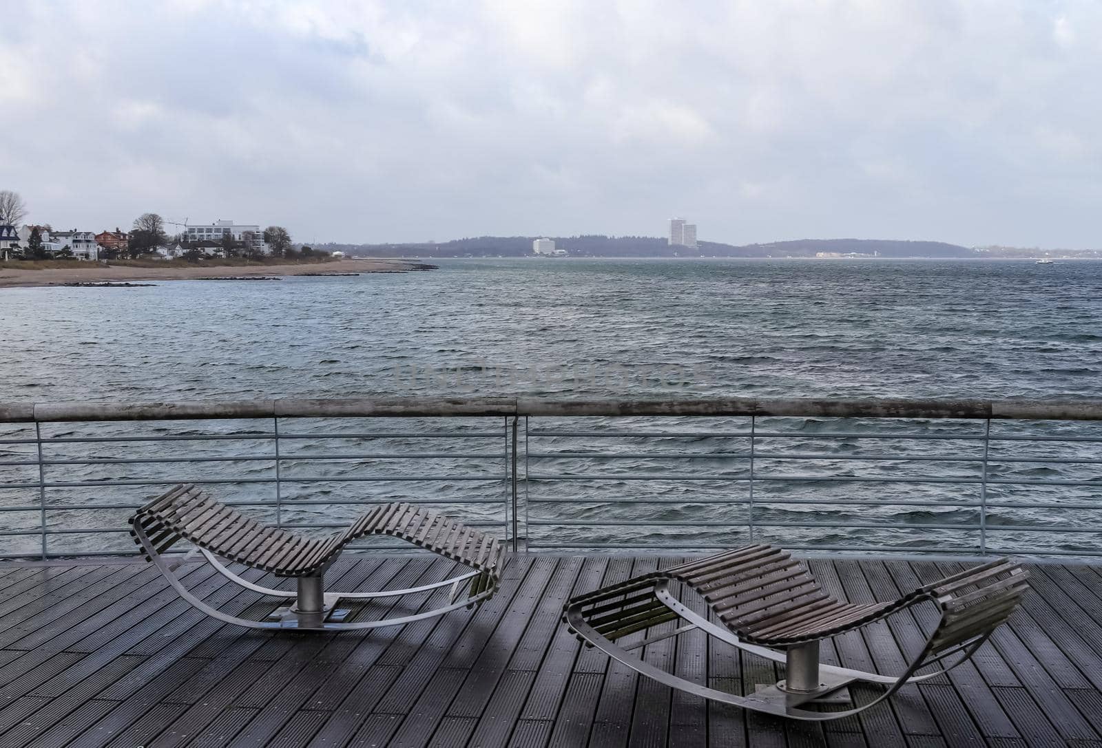 Niendorf, Germany - 30.January 2022: View of the stormy Baltic Sea at a pier in Niendorf on Timmendorfer Strand