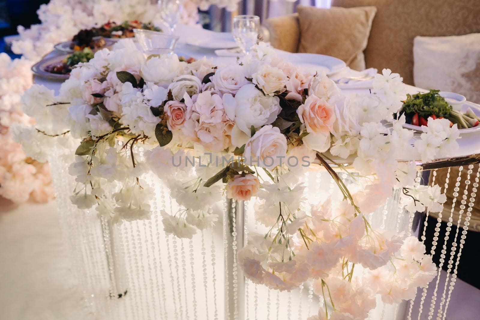 Decorated Table for a wedding reception in a restaurant .Wedding decor by Lobachad