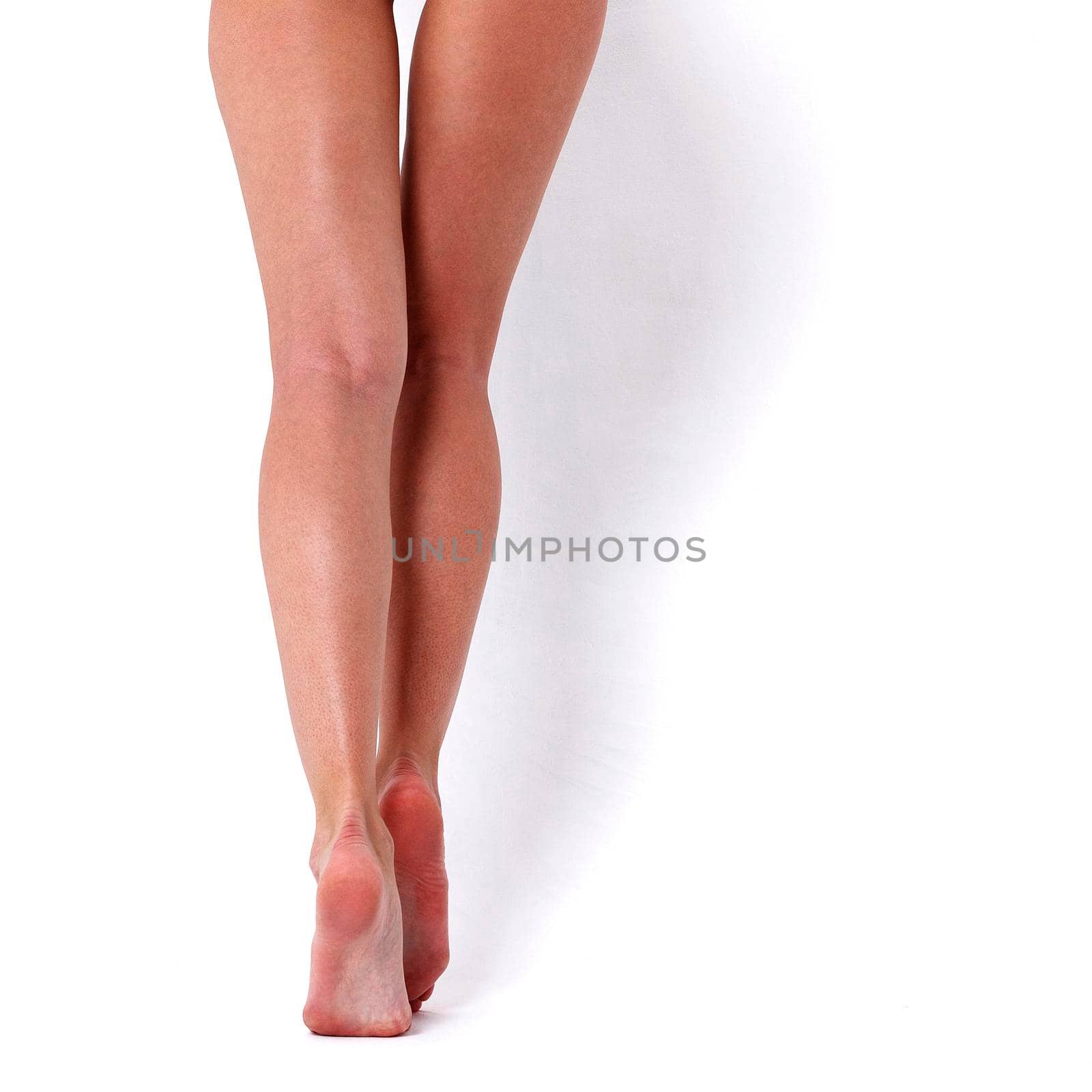 Long woman legs on white background by Nobilior