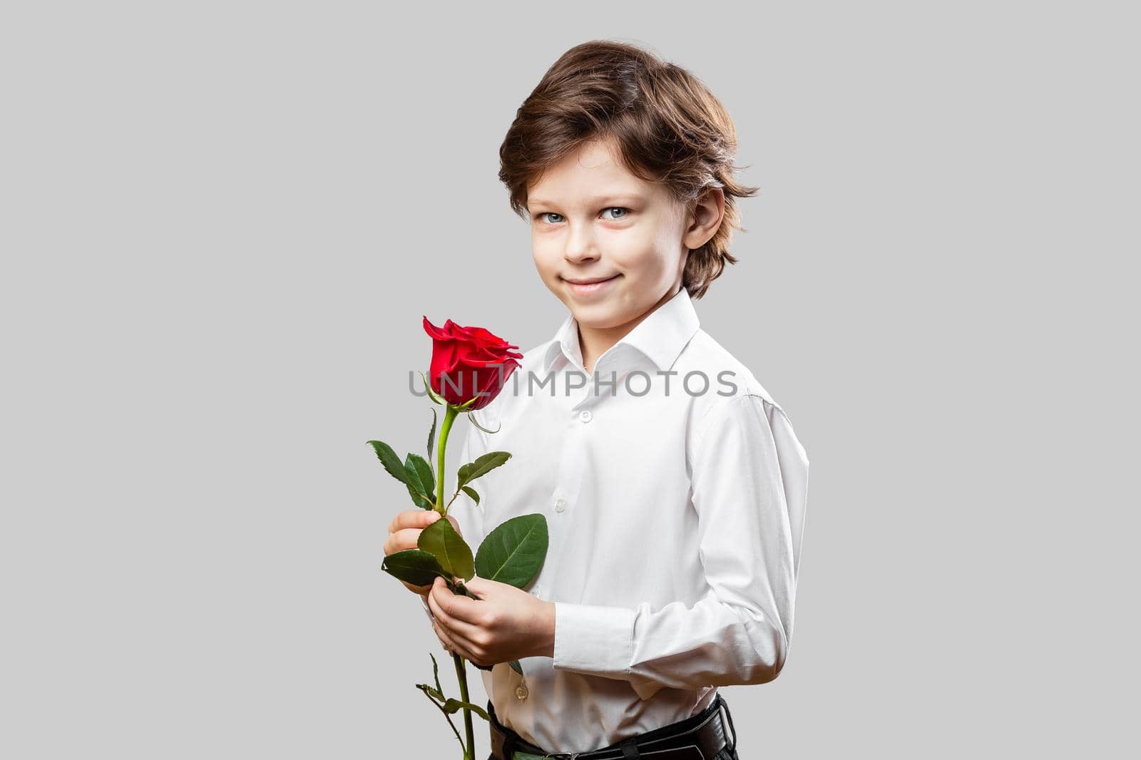 Boy holding a red rose flower for Valentines day by Syvanych