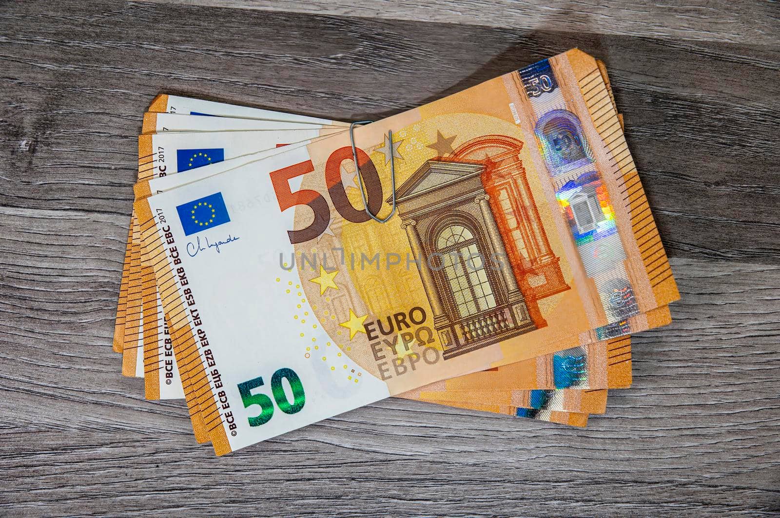 50 euro banknote wad with pin on wooden top