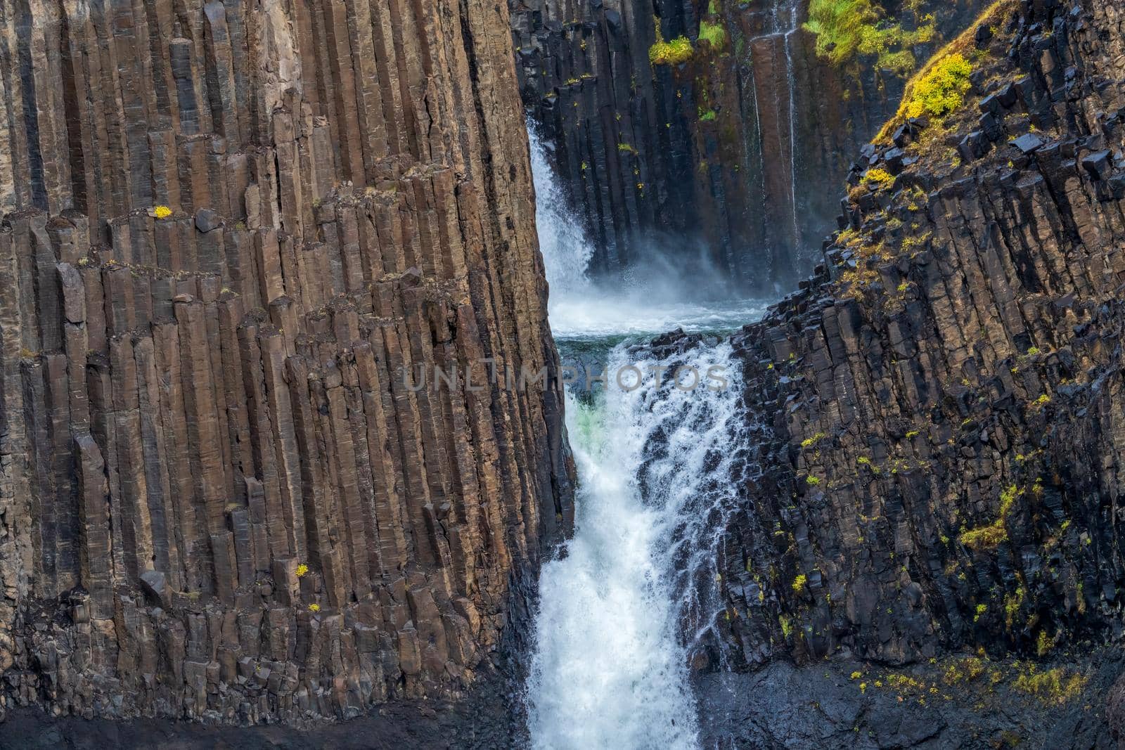 Closeup view of waterfall and basaltic rock walls