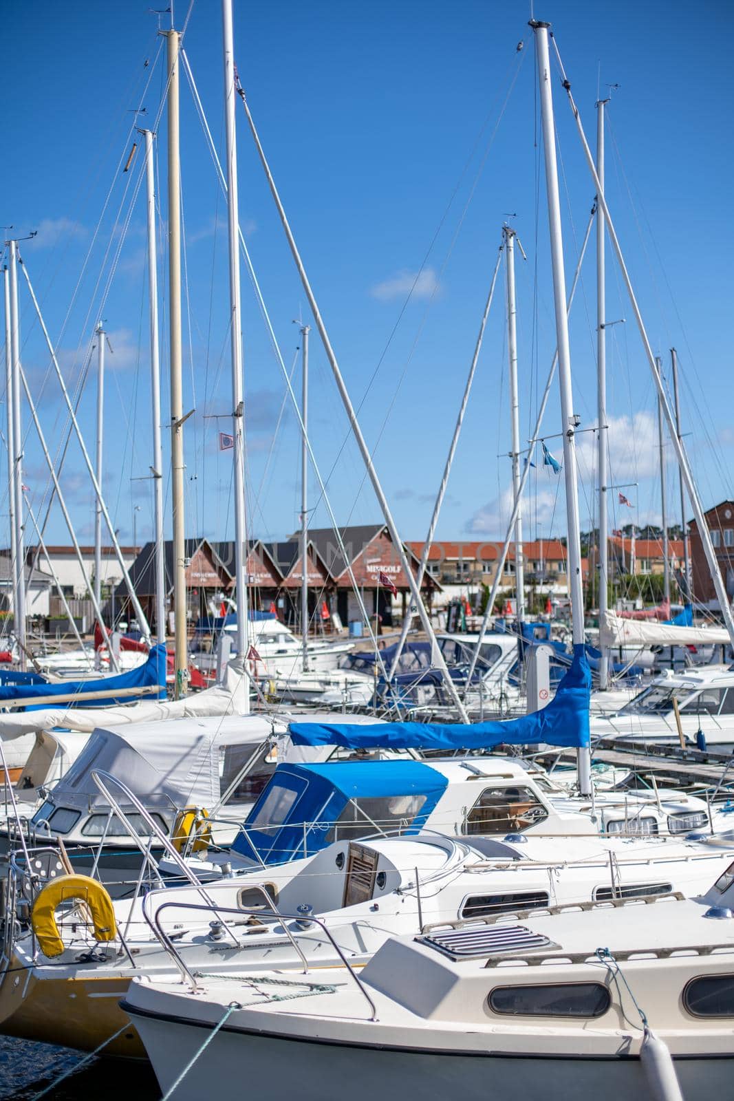 Hundested, Denmark - July 09, 2020: Sailboats anchored at the small local harbour.