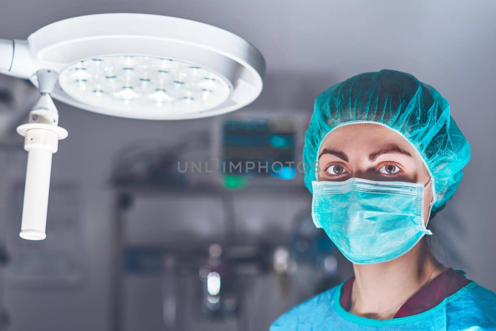 Female surgeon in operating theater by HERRAEZ