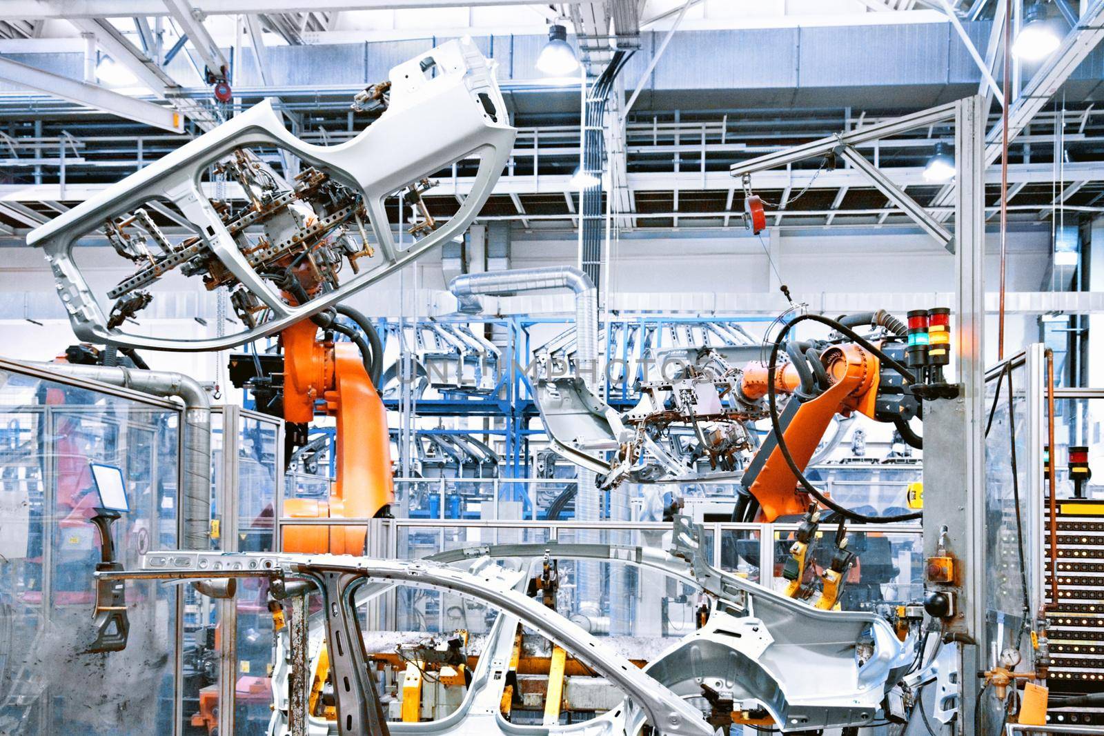 robotic arms in a car factory