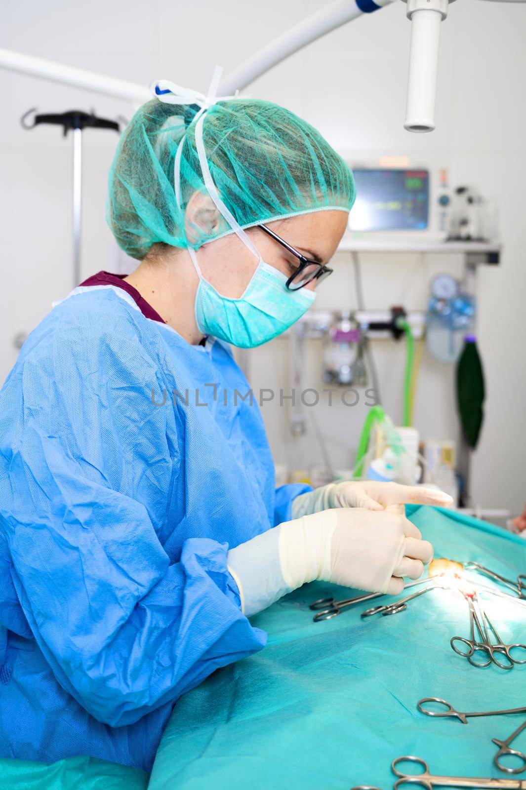 Surgery operation. Close up of surgeon hands stitching the wound after operating. Surgical treatment concept. Surgeon hands performing operation with surgery tools. High quality photography