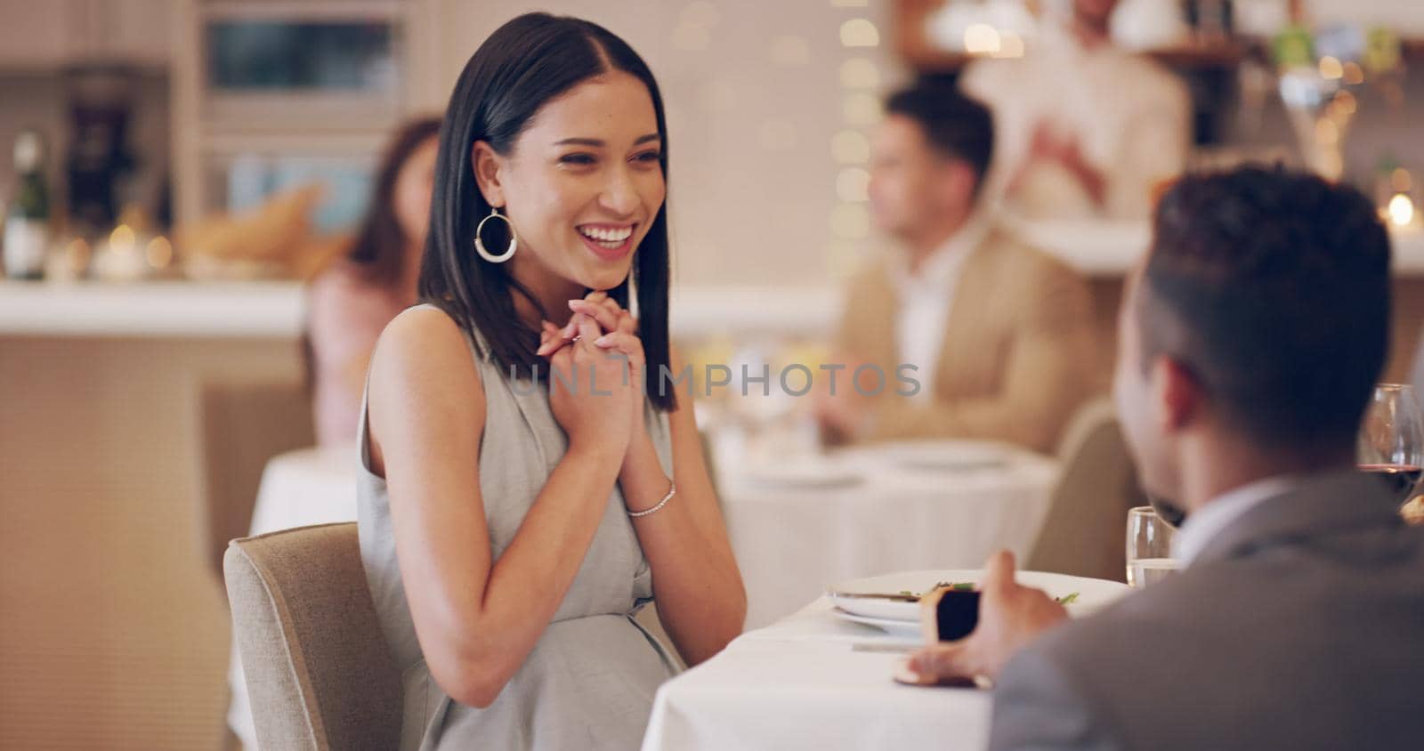 4k video footage of a woman looking surprised while her boyfriend proposes at a restaurant