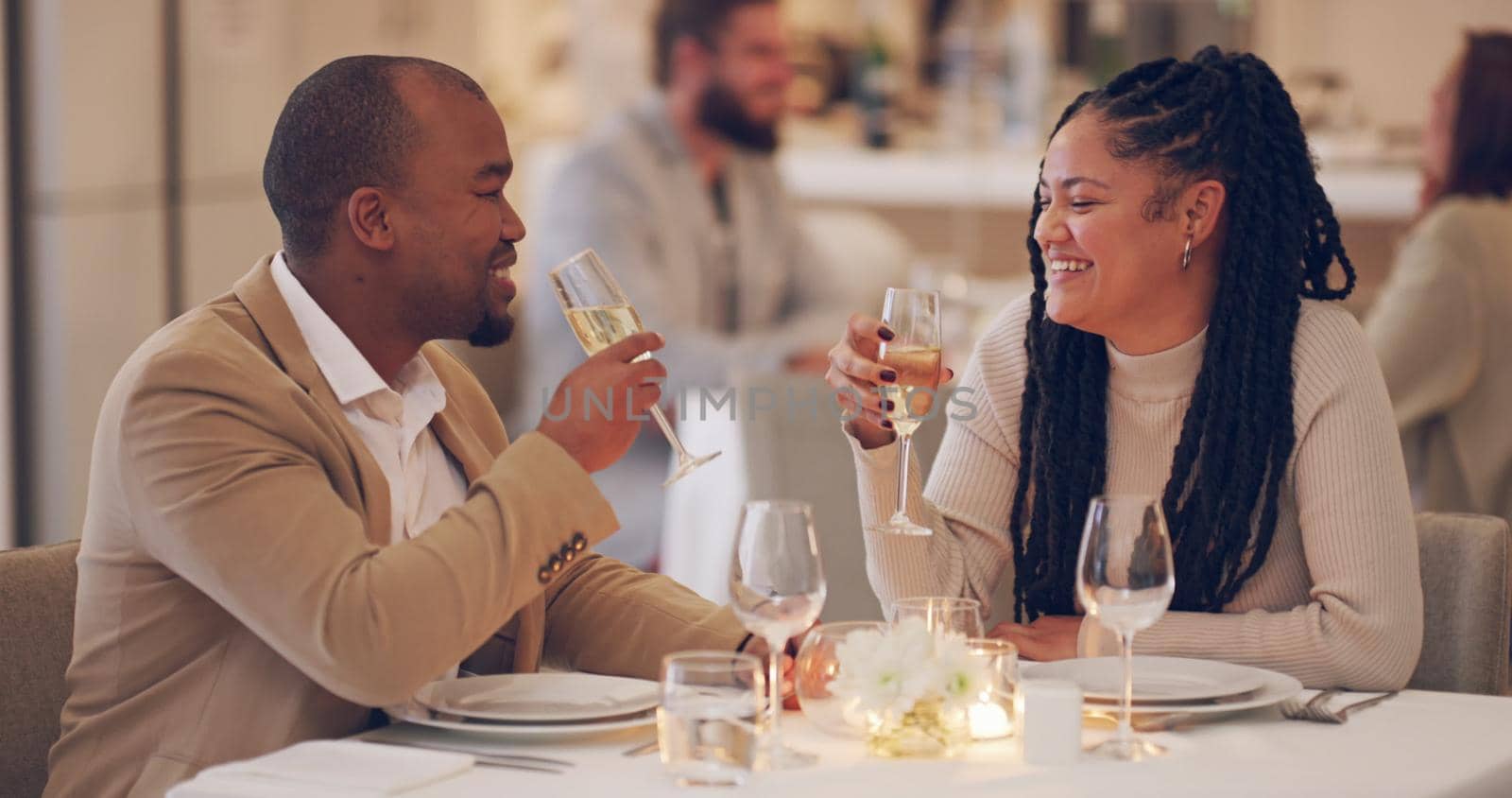 Tonight is all about celebrating us. 4k video footage of a couple making a toast while on a date at a restaurant. by YuriArcurs